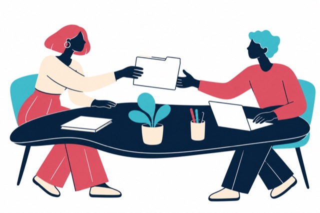 Two bookkeepers share a neatly prepared client folder.